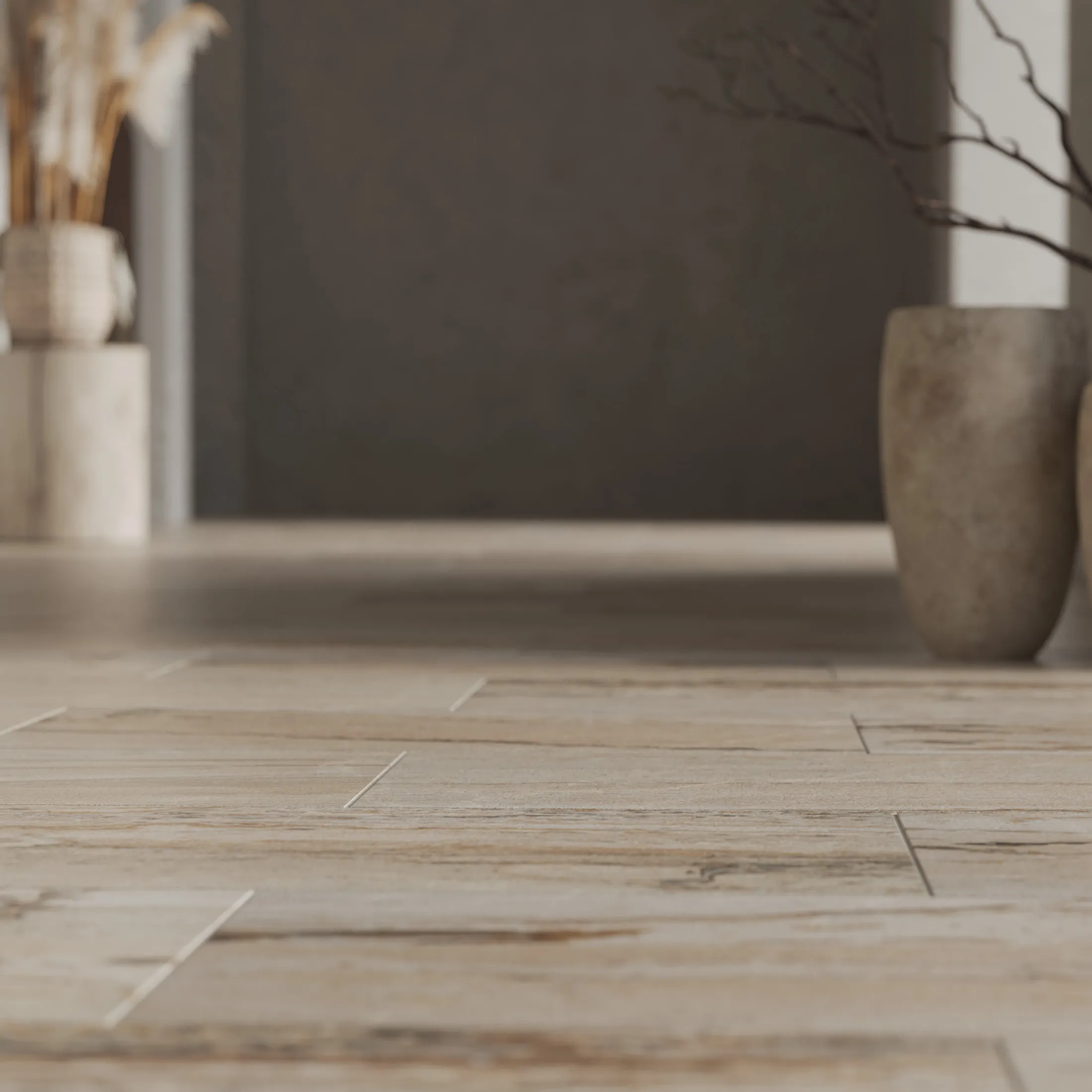 Macro of the same travertine-look floor tile at grazing angle, the shallow focus showing surface veining and the fine joint between two slabs.